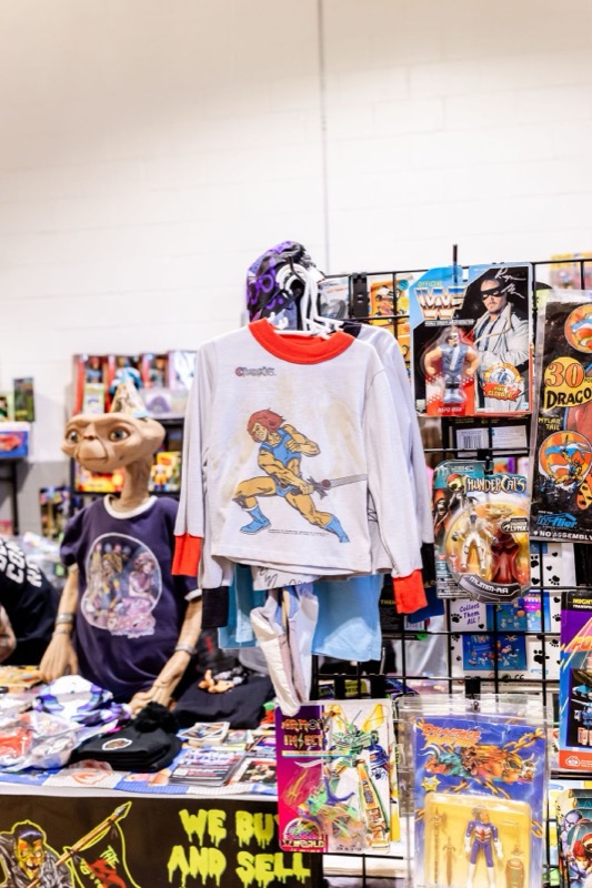 An E.T. bust and ThunderCats sweatshirt displayed with vintage carded figures